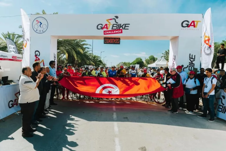 Ligne de départ du GatBike Challenge à Carthage avec les participants et le drapeau tunisien, organisé par Ask'Event.